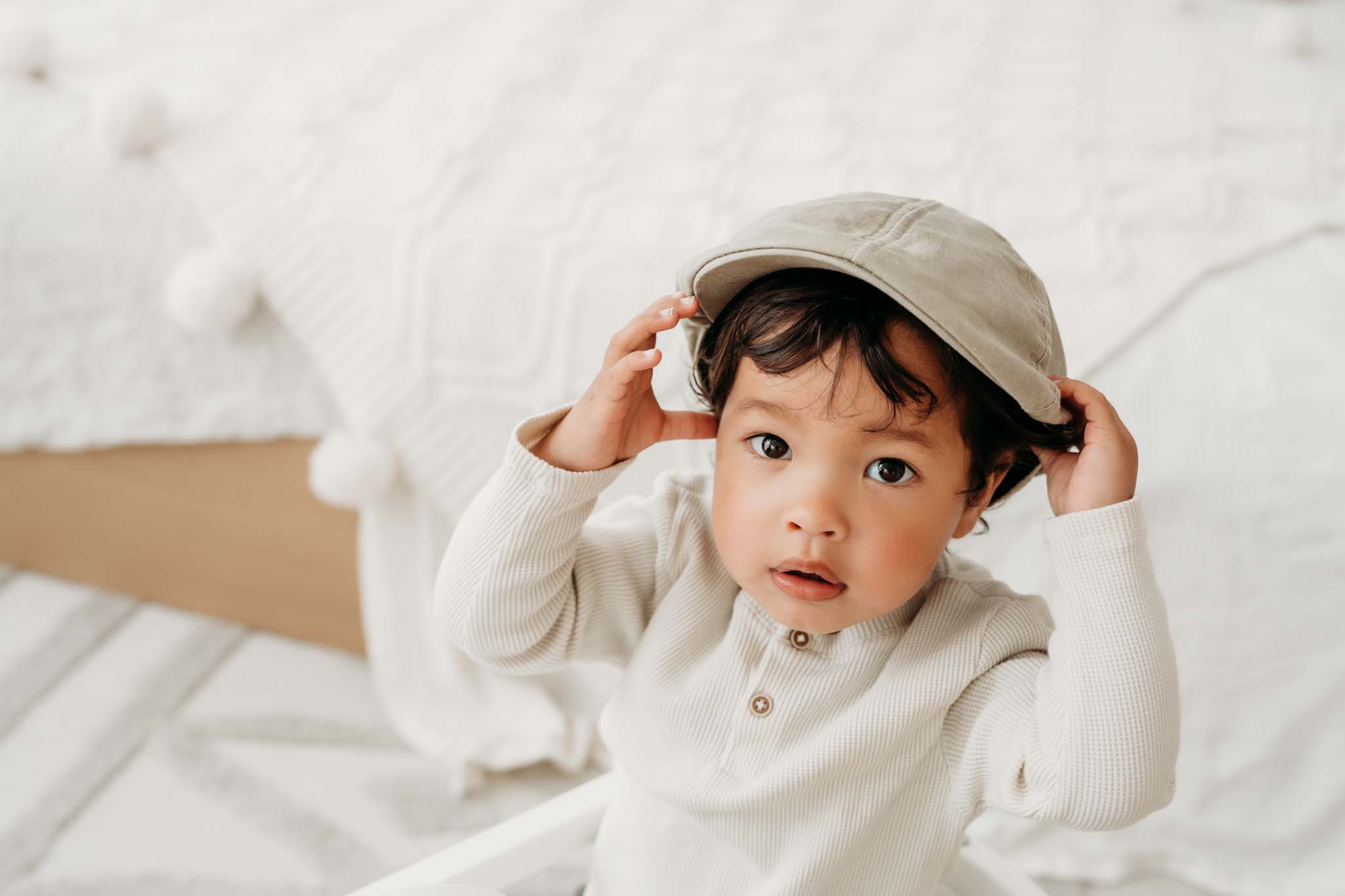 Junge hält Hut fest beim Babyshooting